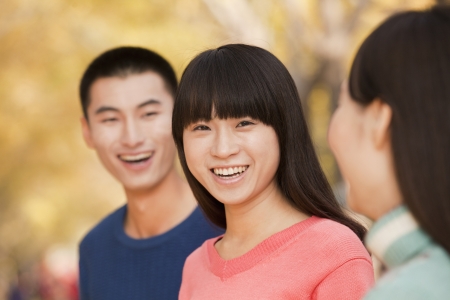Young people enjoying a park in autumnの写真素材