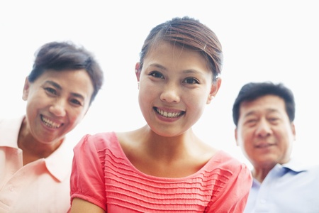 Daughter with her parents smiling, portrait