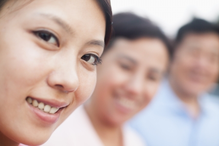 Woman smiling with her parents, portraitの写真素材
