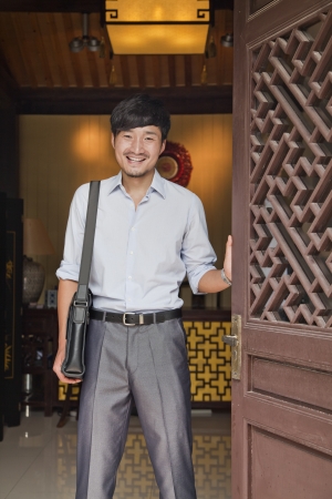Young Businessman in Traditional Doorwayの写真素材