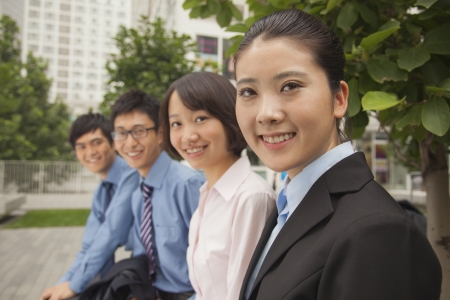 Young business people smiling and looking at the camera, portraitの写真素材