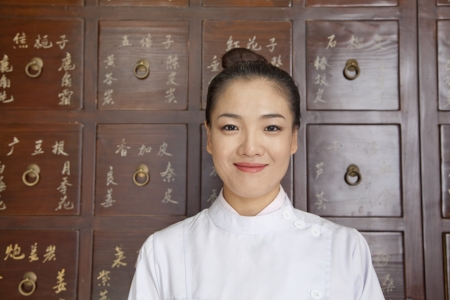 Portrait of Doctor In Front of Traditional Chinese Medicine Cabinetの写真素材