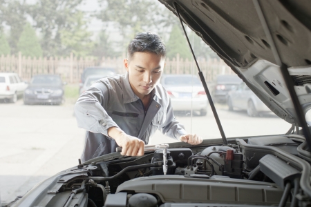Garage Mechanic Working on Engineの写真素材