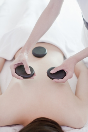Woman Receiving Hot Stone Massageの写真素材