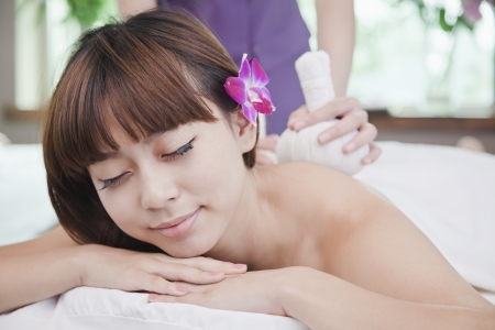 Woman Receiving Herbal Massageの写真素材