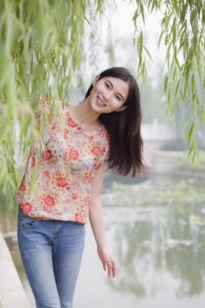Young Woman By a Canal Smilingの写真素材