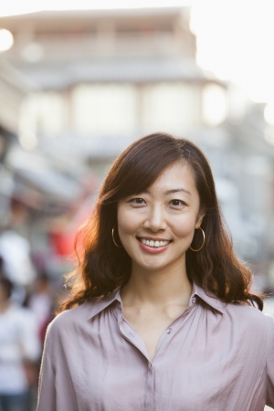 Portrait Of Smiling Mid Adult Woman In Houhai, Beijingの写真素材