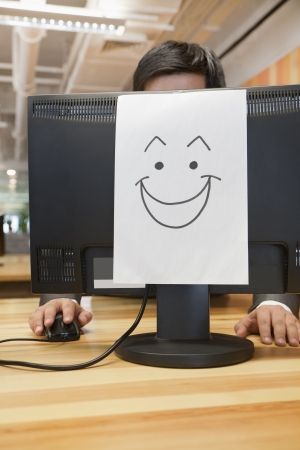 Smiley Face on the Computer in the Officeの写真素材