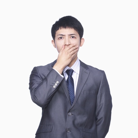 Businessman covering mouth with handの写真素材