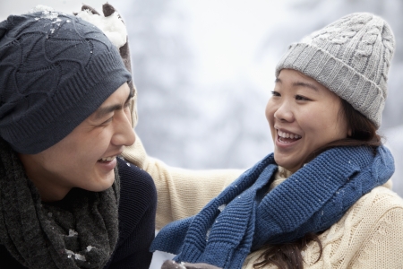 Young Couple Having a Snowball Fightの写真素材