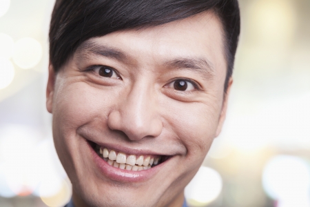Close up portrait of young man smiling, Beijingの写真素材
