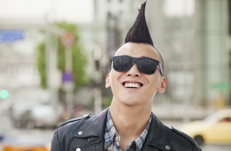 Young man with punk Mohawk smilingの写真素材