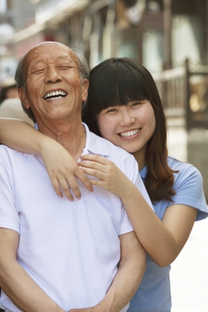 Portrait of grandfather and granddaughter together, outdoors in Beijingの写真素材