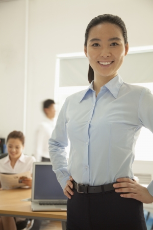 Young woman smiling in the office, portraitの写真素材