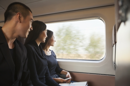 Three Friends Looking Out Train Windowの写真素材