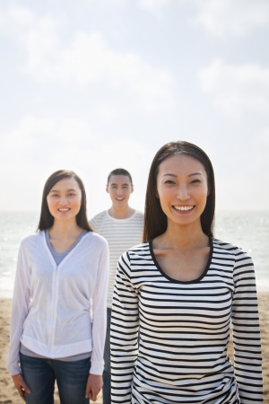 Portrait of Young Woman and Friends at the Beachの写真素材