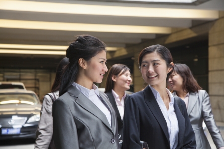 Five young Businesswomen talking in the parking garageの写真素材