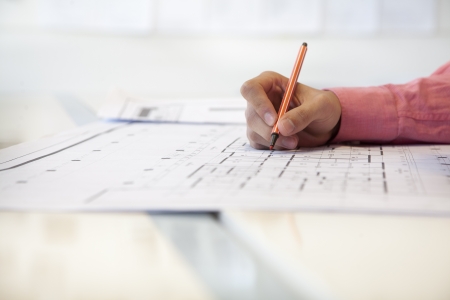 Businessman working on architecture project in the officeの写真素材