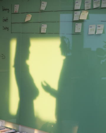 Two Business People Reflected on the Wall Boardの写真素材