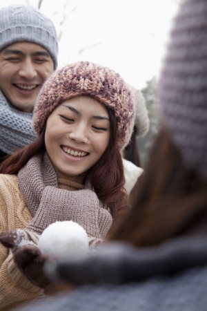 Young Woman Holding a Snowballの写真素材