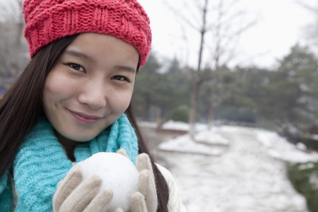 Young Woman with Snowballの写真素材