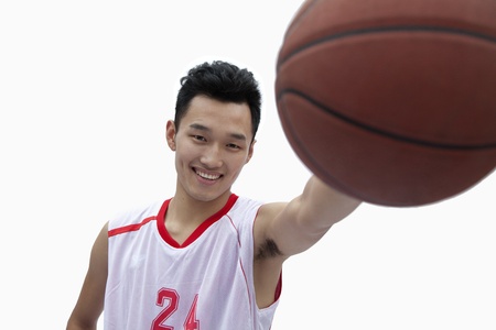Basketball Player Holding Out Basketballの写真素材