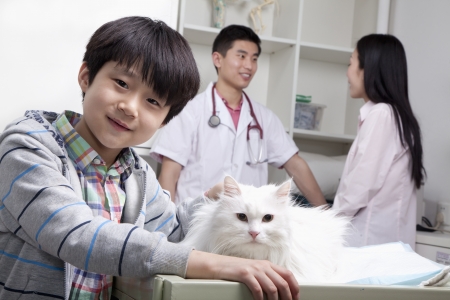 Boy with pet dog in veterinarian's officeの写真素材