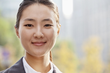 Portrait of young businesswoman smiling outside in Beijing の写真素材