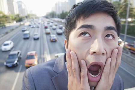 Young Angry Businessman Yelling Over Freewayの写真素材