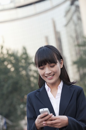 Young Businesswoman texting a messageの写真素材