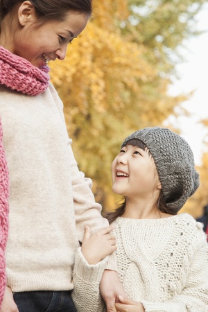 Mother and Daughter Enjoying a Park in Autumnの写真素材
