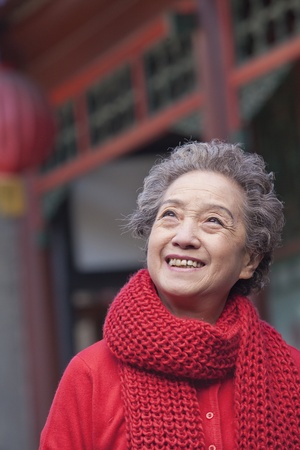 Portrait of senior woman outside a traditional Chinese buildingの写真素材