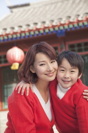 Portrait of mother and son outside traditional Chinese buildingの写真素材
