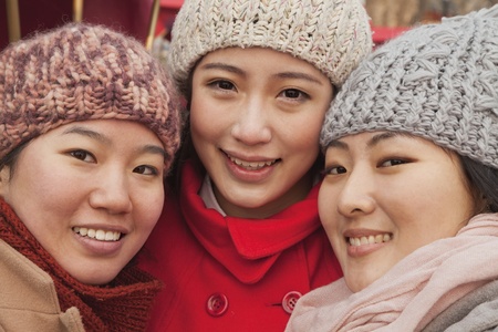Portrait of three friends outdoors in winter, Beijingの写真素材
