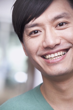 Close up portrait of young man smiling, Beijingの写真素材