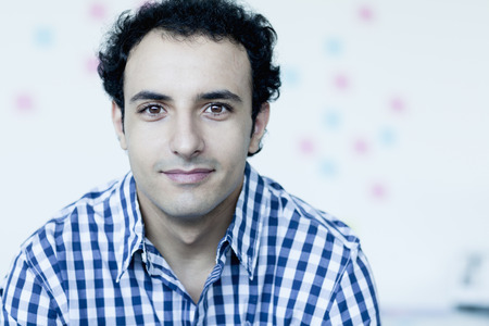Portrait of young businessman in a checkered shirt