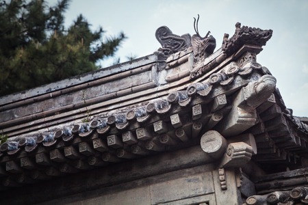 Close-up of ornate roof tiles on Chinese building. の写真素材