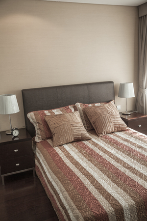 Bright, modern bedroom with striped bedspread.