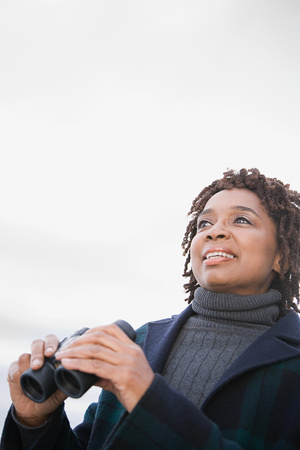 A woman holding binocularsの写真素材