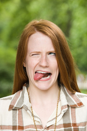 Ginger haired girl making facesの写真素材