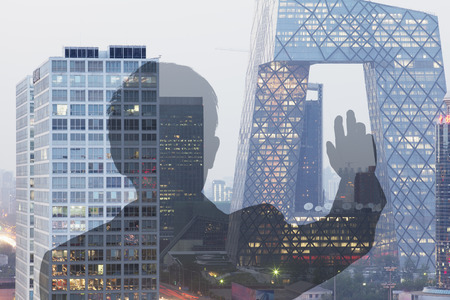 Businessman looking at CCTV building in Beijing, Double exposureの写真素材