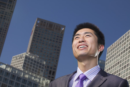 Portrait of young businessman outside in the business district, Beijingの写真素材