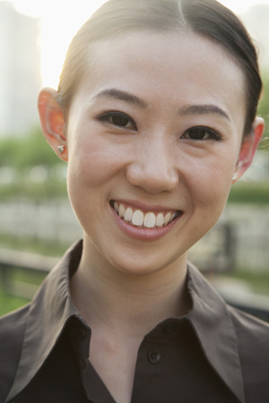 Close-up portrait of young woman outside, Beijingの写真素材