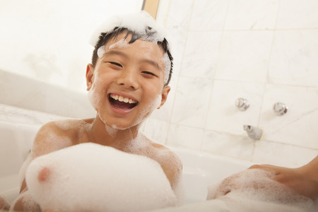 Close-up of Kid in Bubble Bathの写真素材