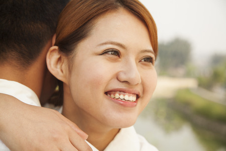 Young Woman Hugging Her Boyfriendの写真素材