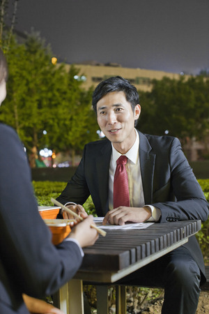 Business People Working While Having Dinnerの写真素材