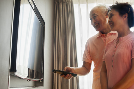 Senior couple watching TVの写真素材