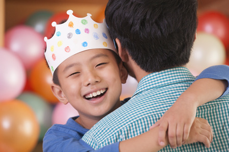 Birthday Boy Hugging His Fatherの写真素材