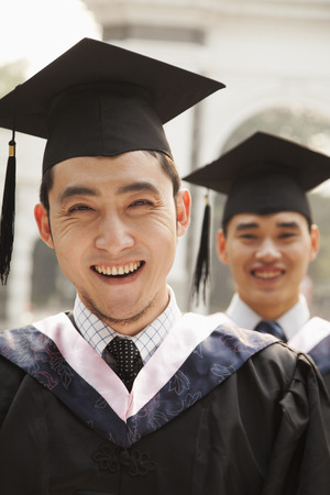 Young Graduates in Cap and Gownの写真素材