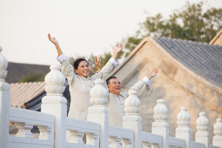 Two seniors practicing Taijiquan in Beijing, Arms outstretchedの写真素材